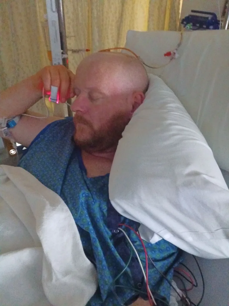 Mickey Rayment recovering in the hospital after a ruptured brain aneurysm
